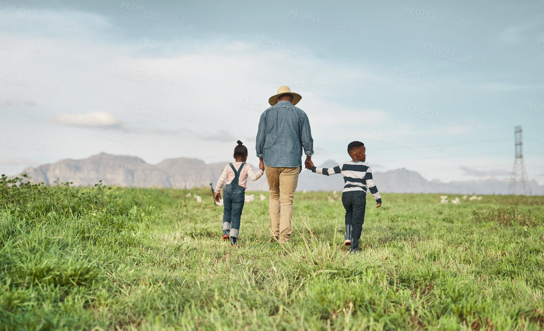 Buy stock photo Rearview shot of a man and his two adorable children exploring a farm