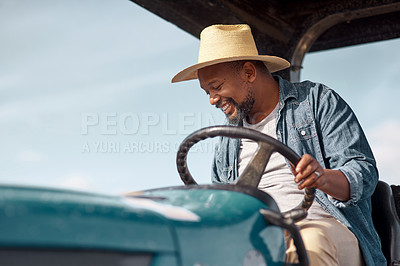 Buy stock photo Shot of a mature man driving a tractor on a farm