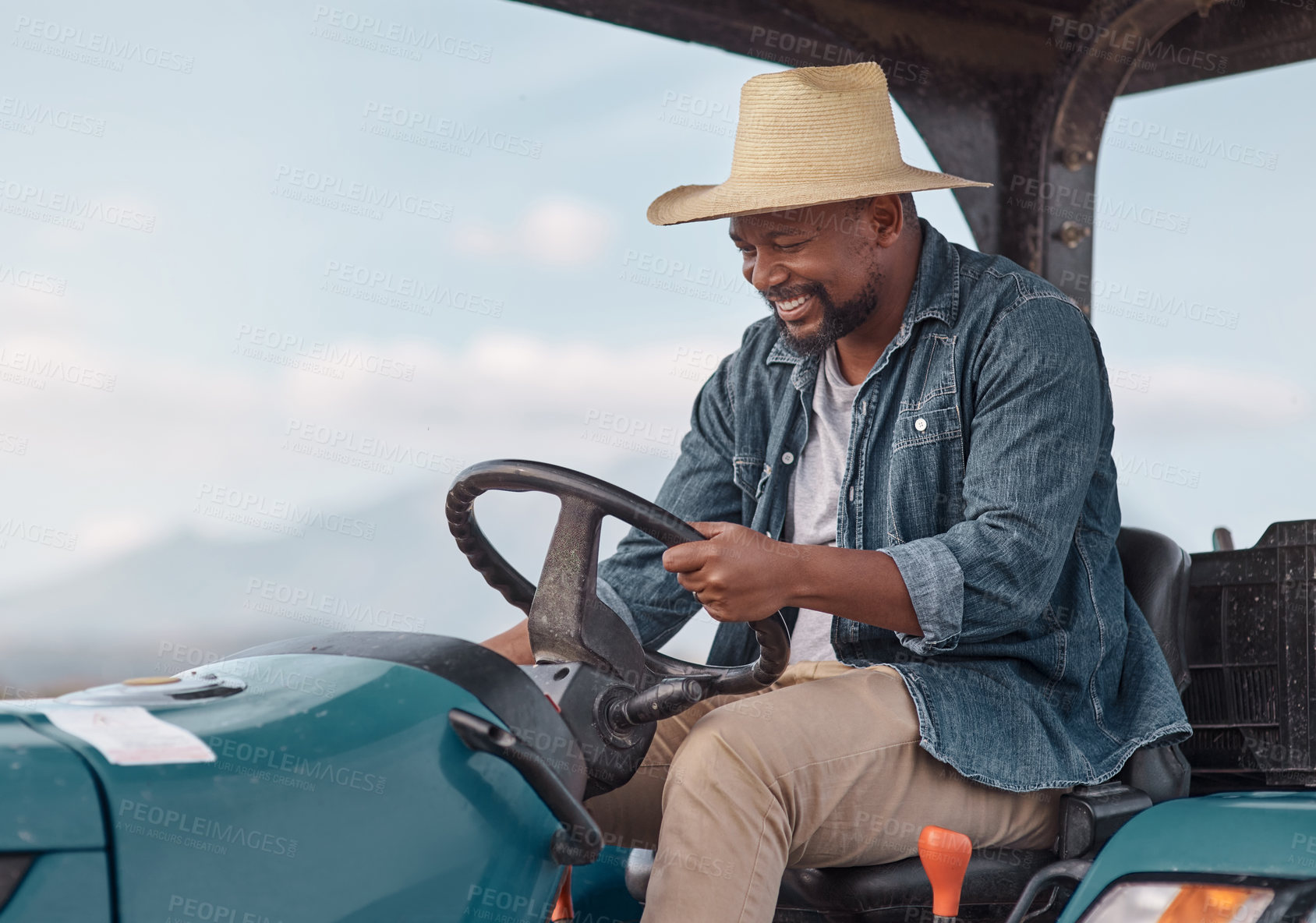 Buy stock photo Shot of a mature man driving a tractor on a farm