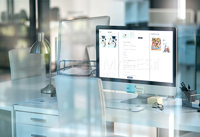 Buy stock photo Shot of a desktop computer on a desk in a modern office shot through glass