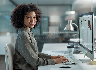 Buy stock photo Shot of a smiling young female agent working in a call centre looking away from her workstation