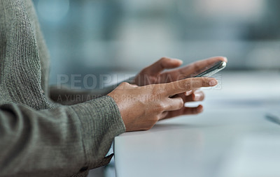Buy stock photo Cropped image of an unrecognisable businesswoman using her mobile phone in the office
