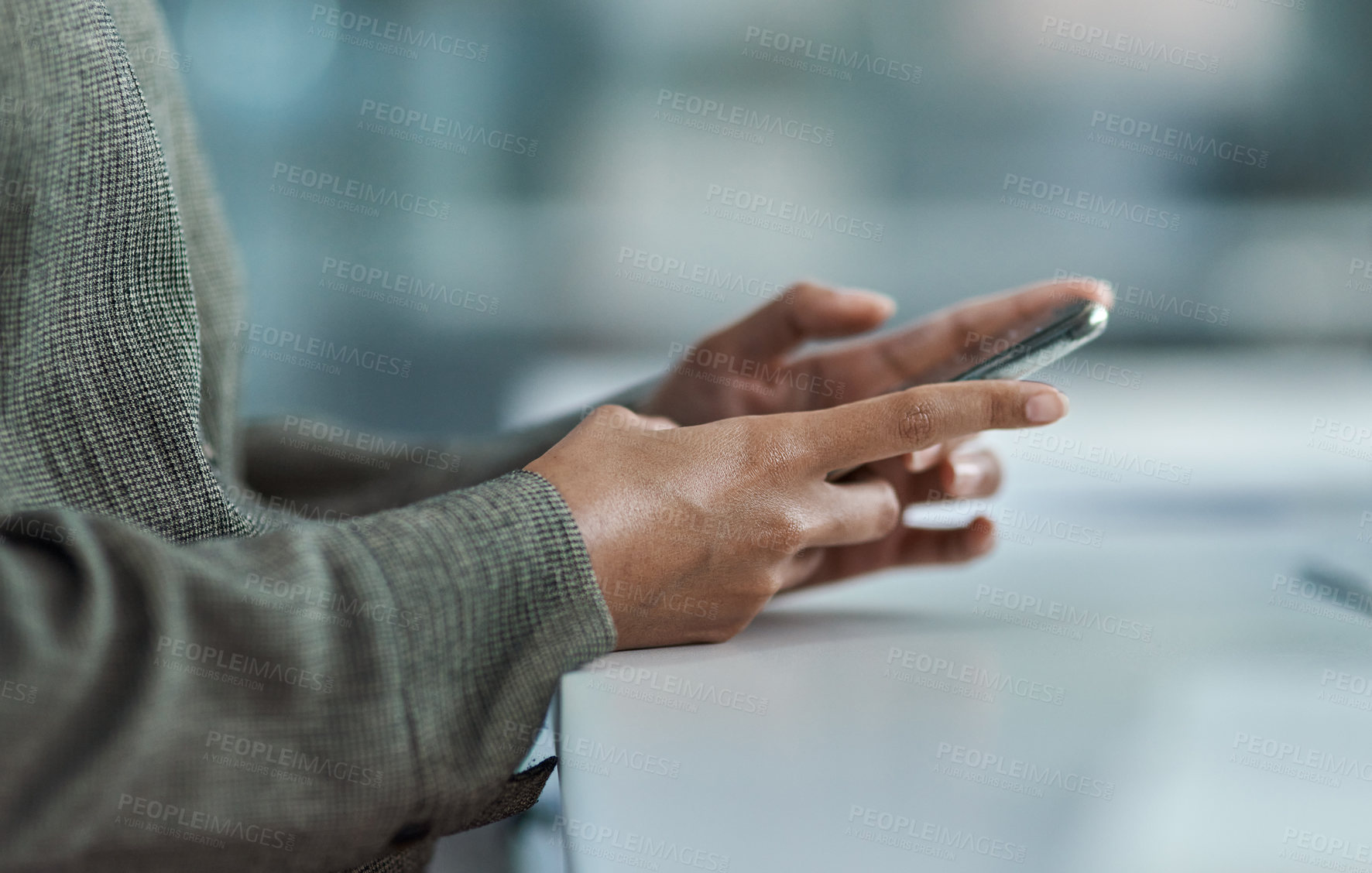 Buy stock photo Cropped image of an unrecognisable businesswoman using her mobile phone in the office