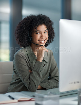 Buy stock photo Shot of a young female agent working in a call centre with her hand posed on her chin