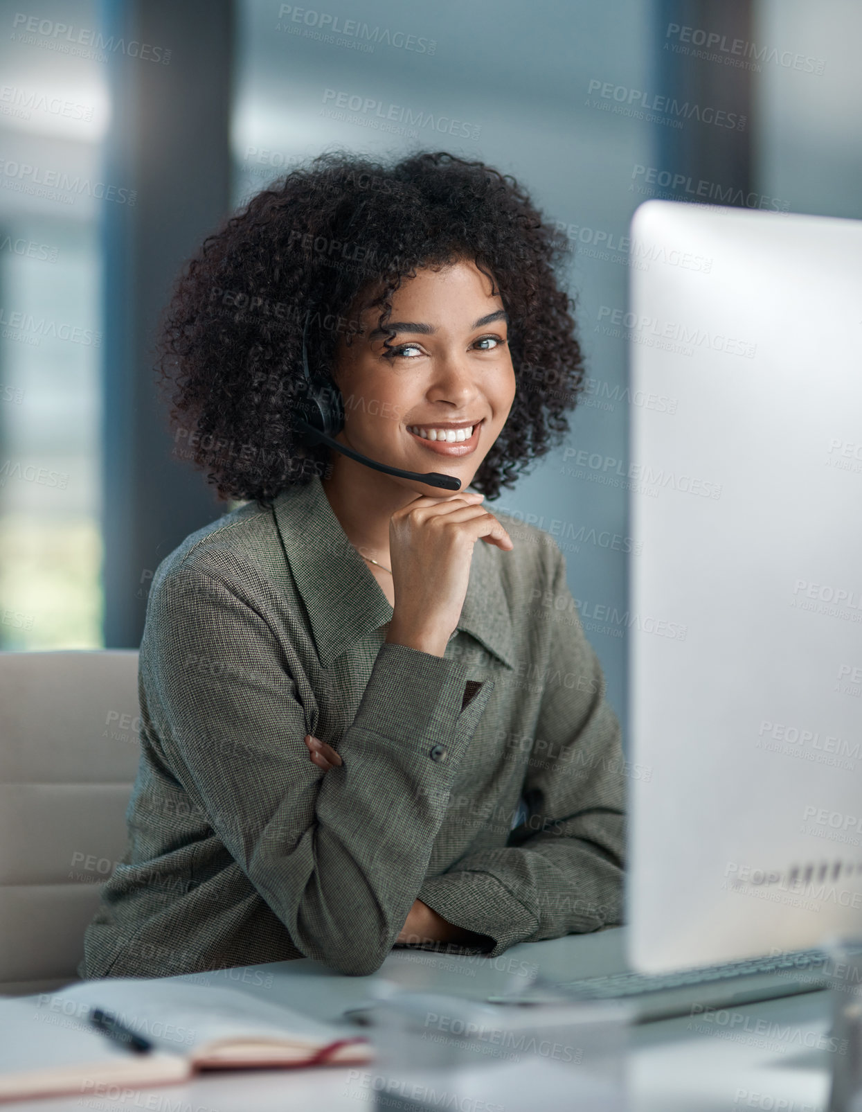 Buy stock photo Shot of a young female agent working in a call centre with her hand posed on her chin