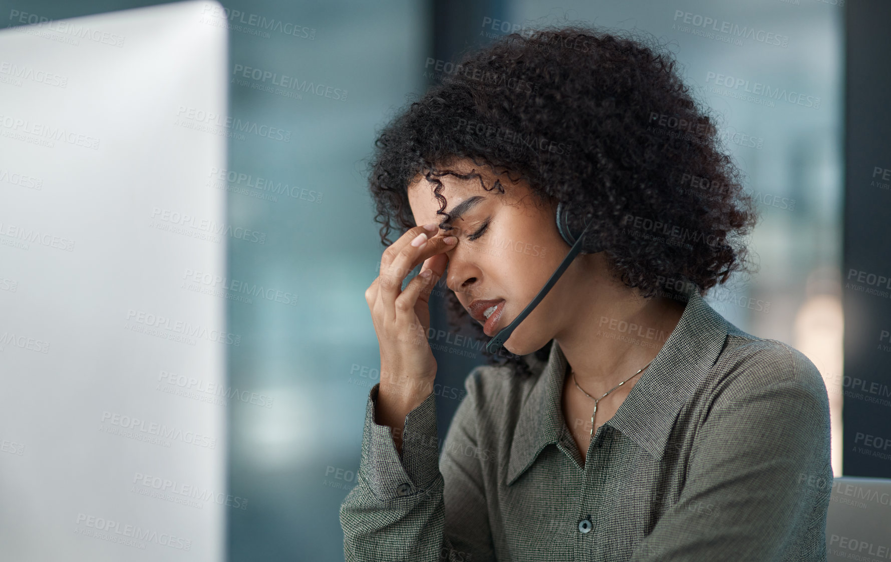 Buy stock photo Cropped shot of a stressed young female agent taking a moment while working in a call centre