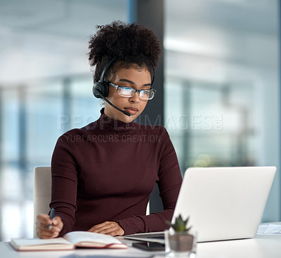 Buy stock photo Shot of a young female agent listening intently while working in a call centre
