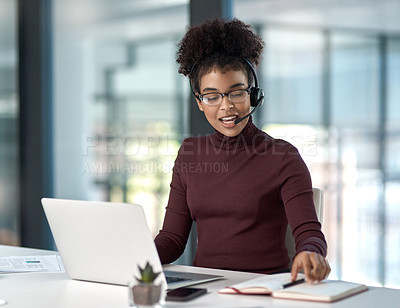 Buy stock photo Shot of a young female agent working in a call centre gesturing at a note on her work-pad