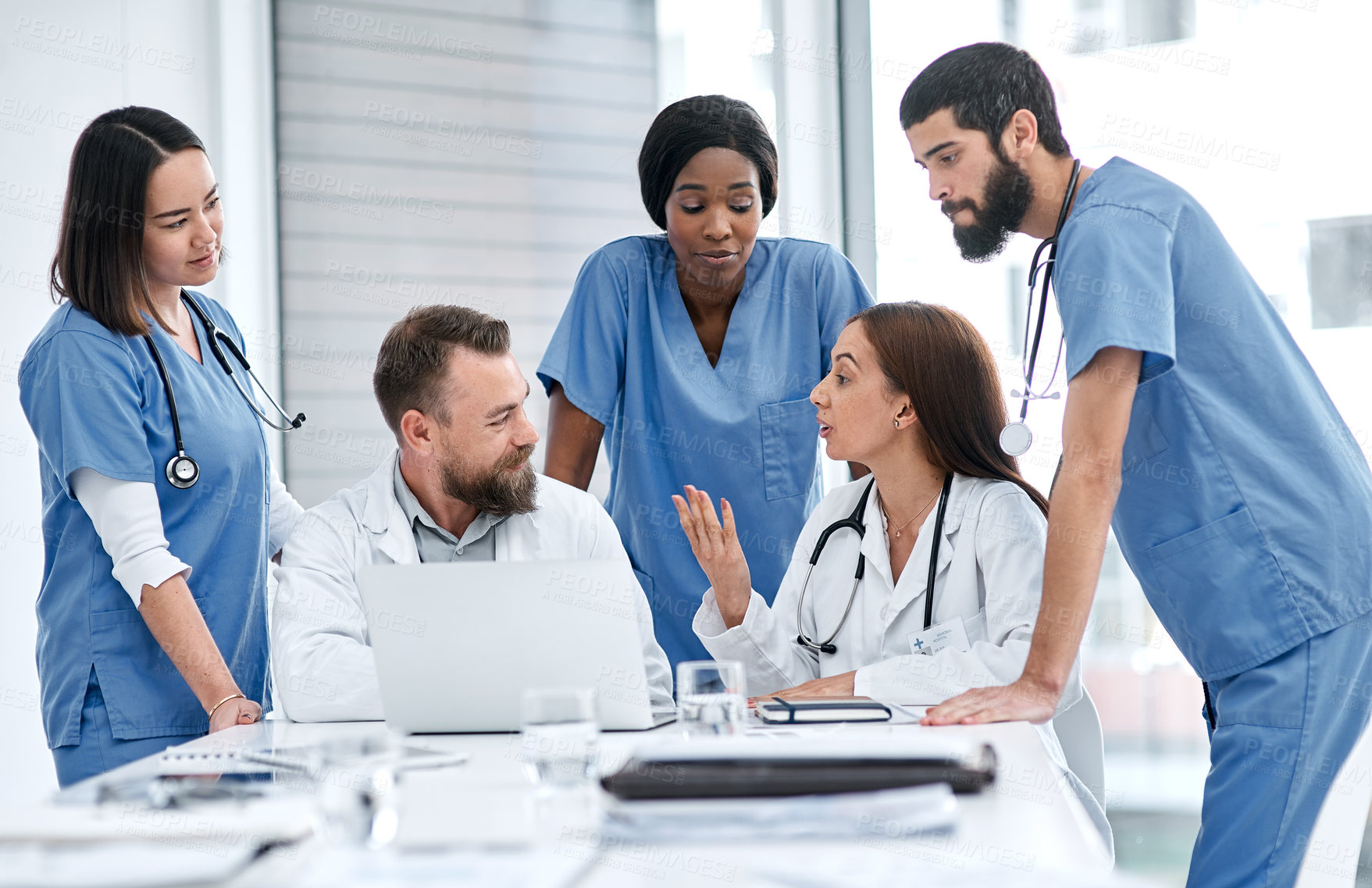 Buy stock photo Shot of a group of medical practitioners having a meeting in a hospital boardroom