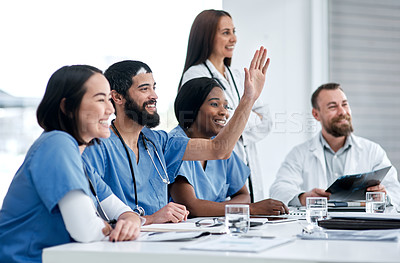 Buy stock photo Shot of a doctor raising his hand during a meeting in a hospital boardroom