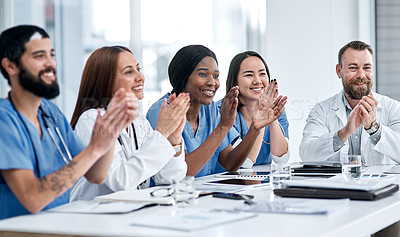 Buy stock photo Shot of a group of medical practitioners applauding during a meeting in a hospital boardroom