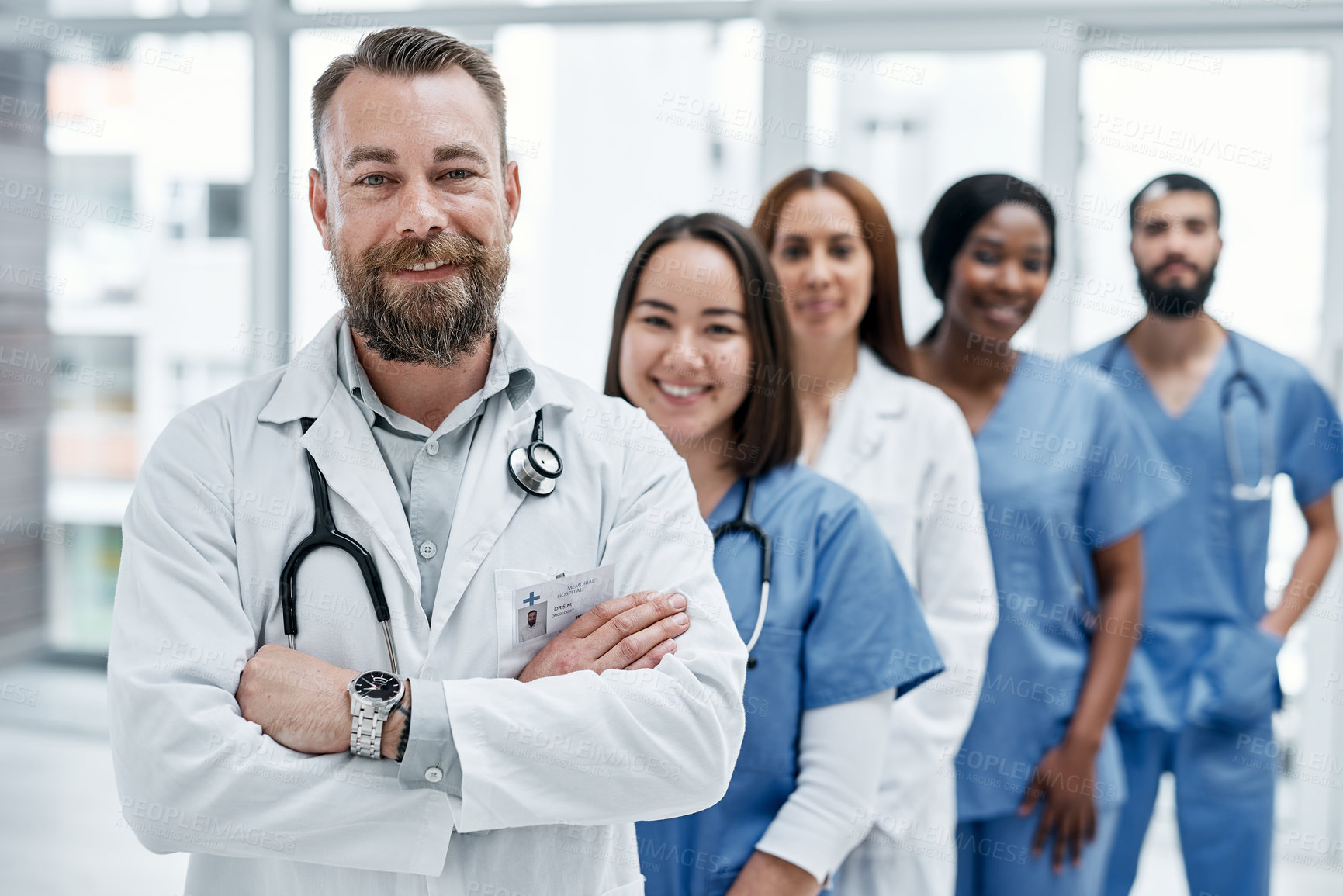 Buy stock photo Portrait of a group of medical practitioners standing together in a hospital