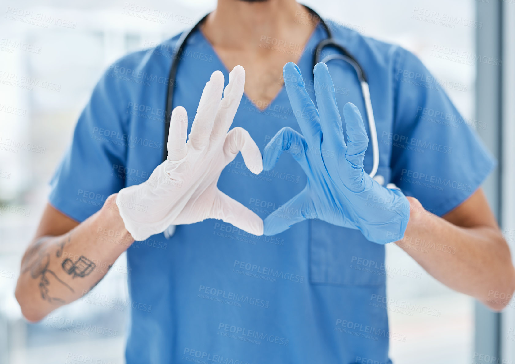 Buy stock photo Closeup shot of a medical practitioner making a heart shape with his hands