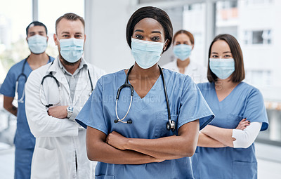 Buy stock photo Portrait of a group of medical practitioners wearing face masks in a hospital