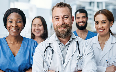 Buy stock photo Portrait of a group of medical practitioners standing together in a hospital