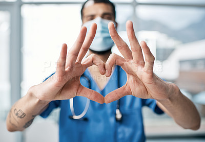 Buy stock photo Closeup shot of a medical practitioner making a heart shape with his hands