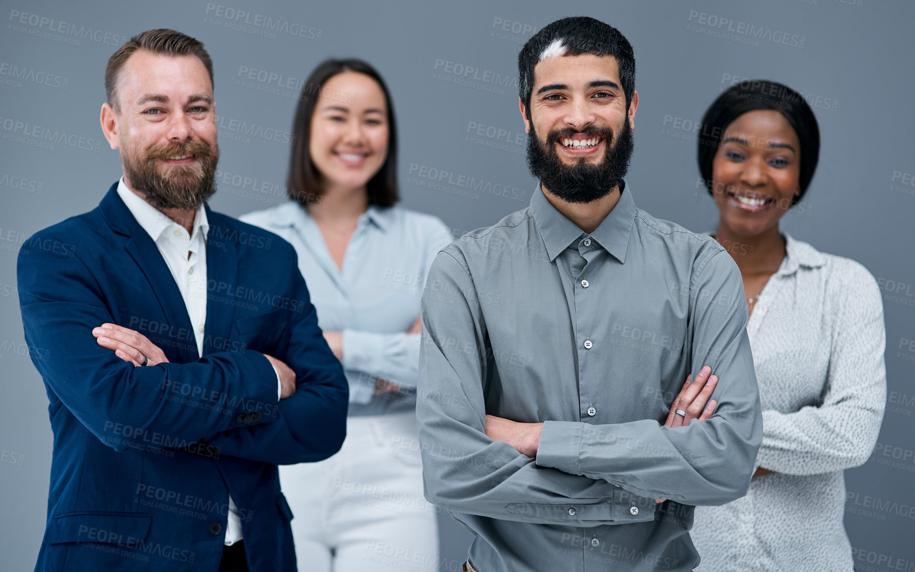 Buy stock photo Portrait of a group of businesspeople standing together against a grey background