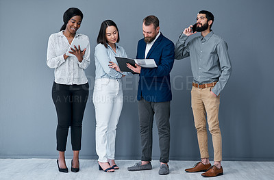 Buy stock photo Shot of a group of businesspeople working against a grey background