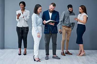 Buy stock photo Shot of a group of businesspeople working against a grey background