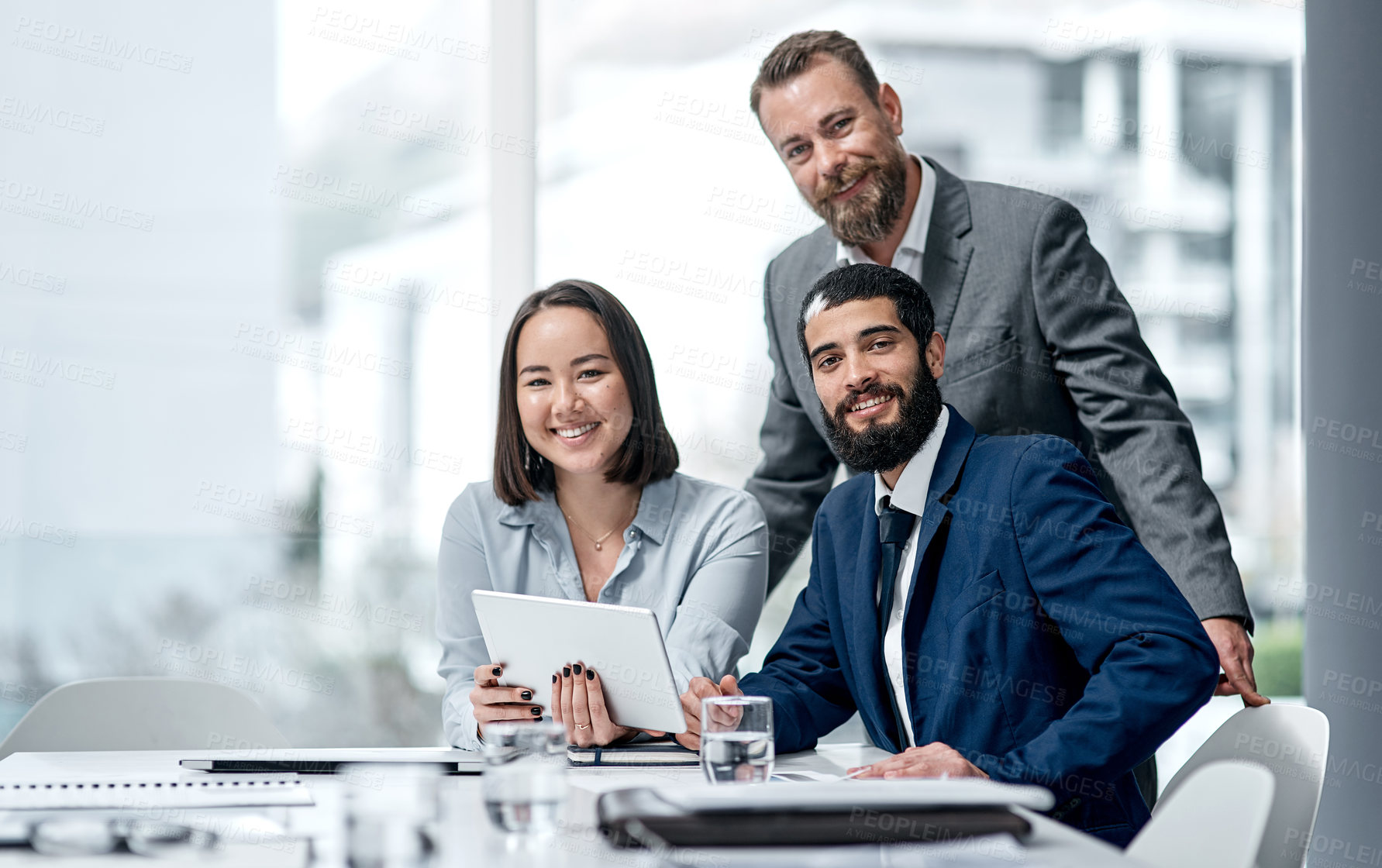 Buy stock photo Portrait of a group of businesspeople working together on a digital tablet in an office