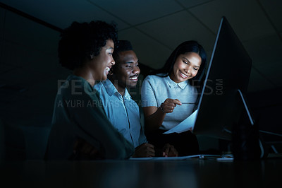 Buy stock photo Shot of a group of young businesspeople using a computer together during a late night at work