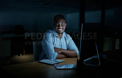 Buy stock photo Portrait of a young businessman using a computer during a late night at work