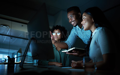 Buy stock photo Shot of a group of young businesspeople using a computer together during a late night at work