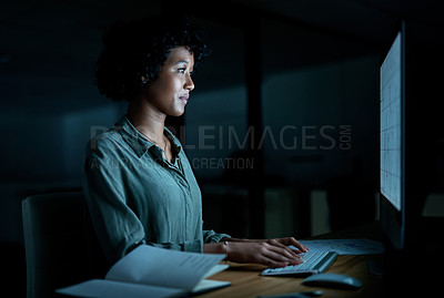 Buy stock photo Shot of a young businesswoman using a computer during a late night at work