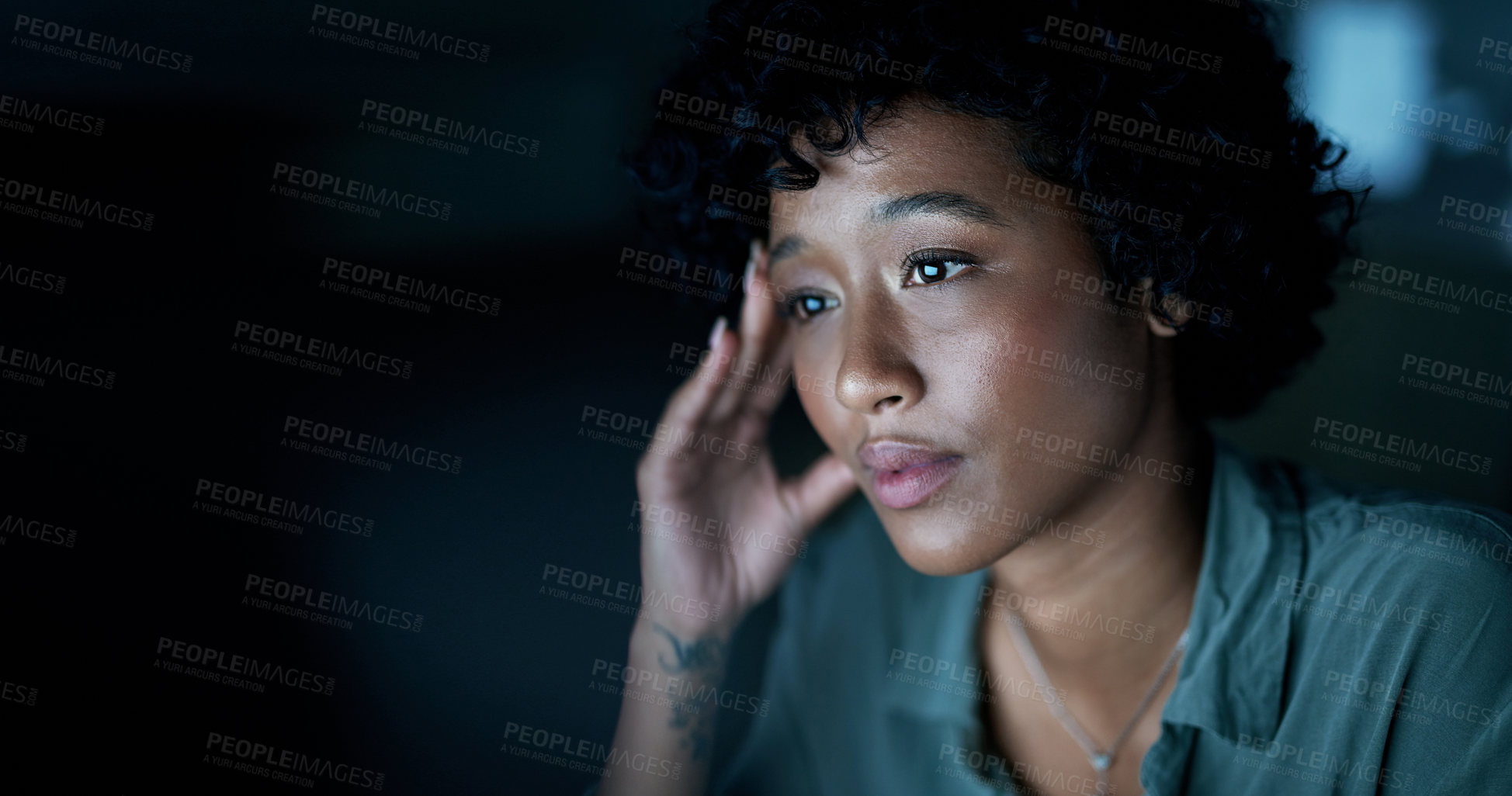 Buy stock photo Shot of a young businesswoman looking stressed during a late night at work