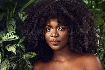 Buy stock photo Shot of a beautiful young woman posing against a leafy background