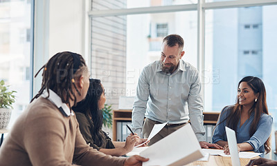 Buy stock photo Cropped shot of a diverse group of businesspeople having a meeting in the office during the day