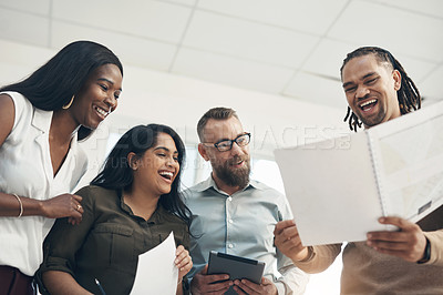 Buy stock photo Cropped shot of a diverse group of businesspeople standing together and laughing in the office during the day