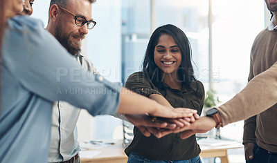 Buy stock photo Cropped shot of a diverse group of businesspeople huddled with their hands piled together in the office