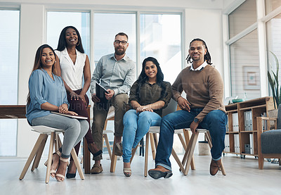 Buy stock photo Full length portrait of a diverse group of businesspeople posing together in the office during the day