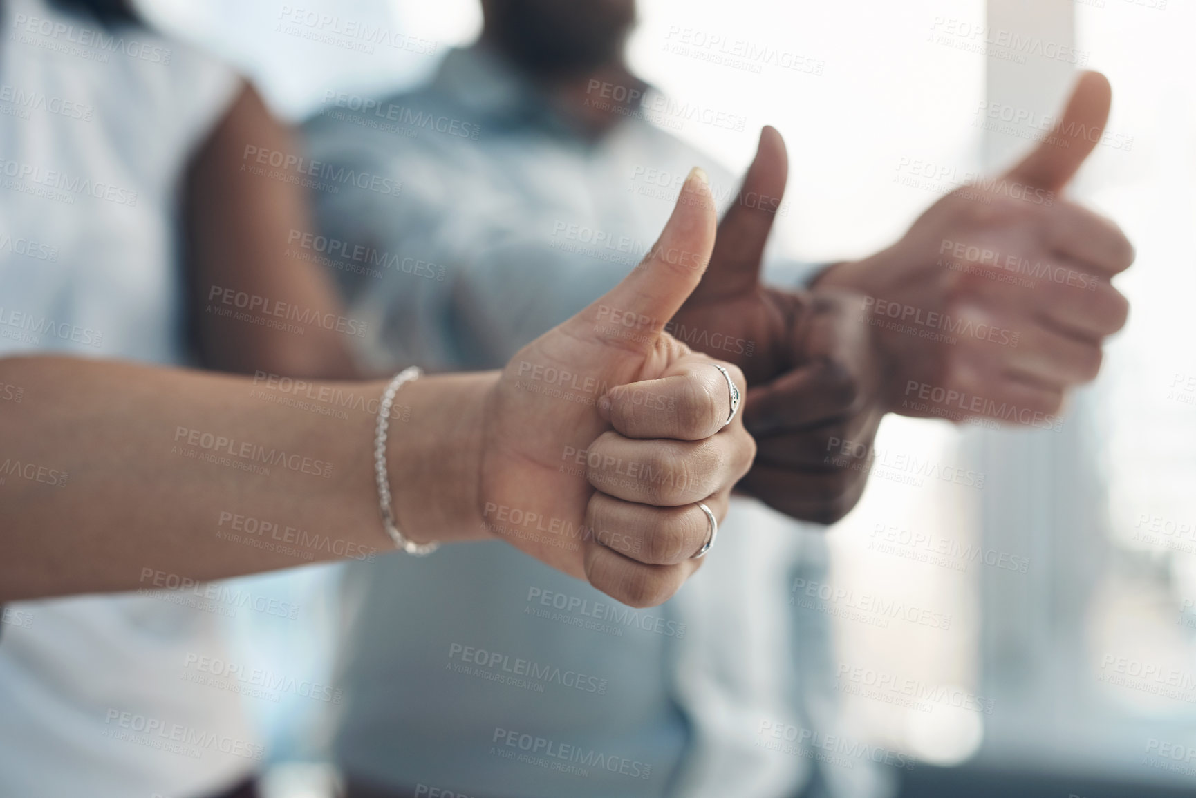 Buy stock photo Cropped shot of an unrecognizable group of businesspeople standing together and making a thumbs-up gesture in the office