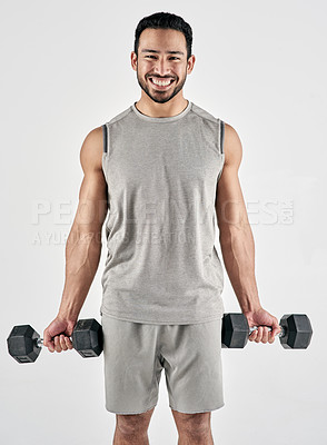 Buy stock photo Studio portrait of a muscular young man exercising with dumbbells against a white background