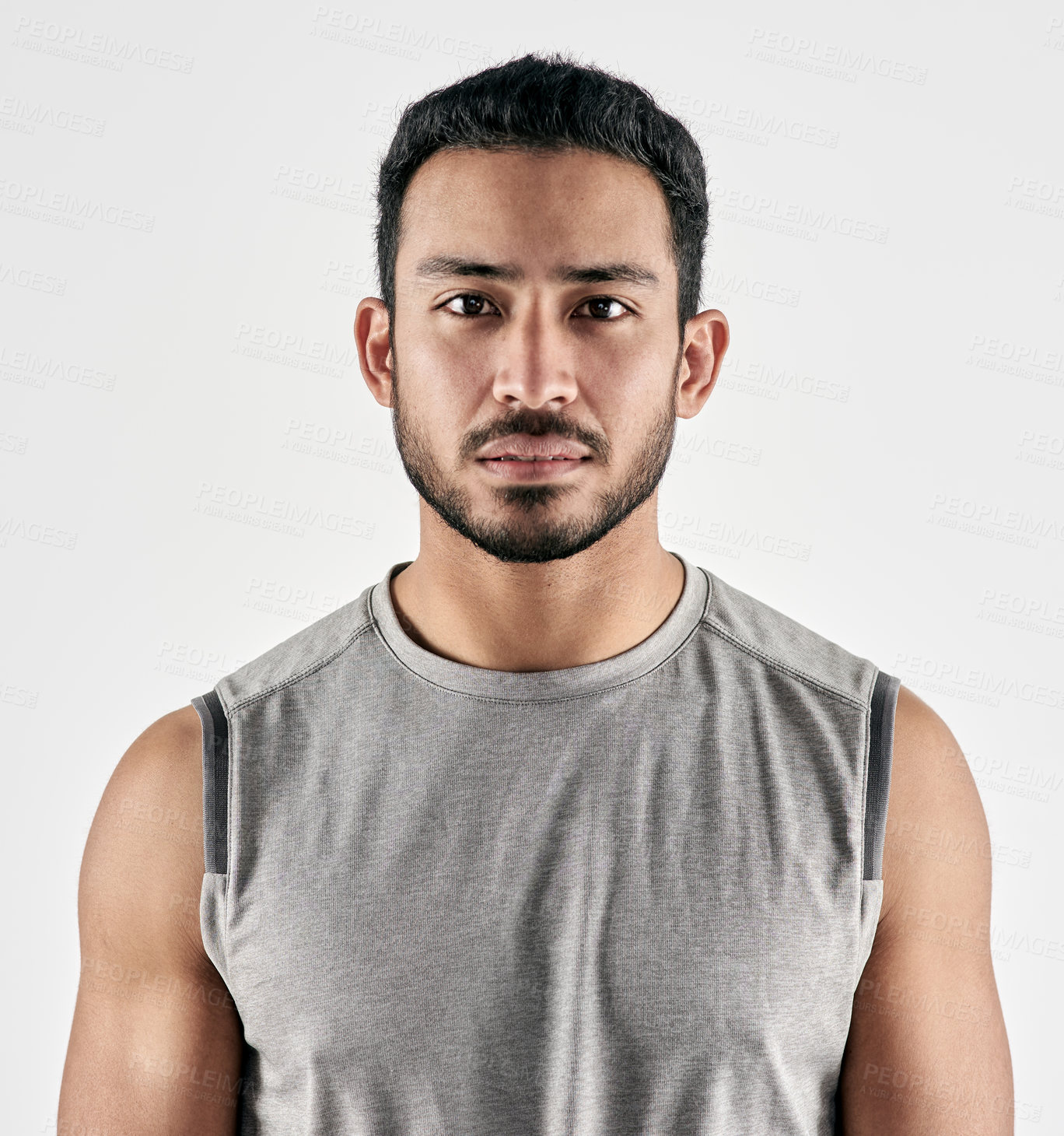 Buy stock photo Studio portrait of a sporty young man posing against a white background