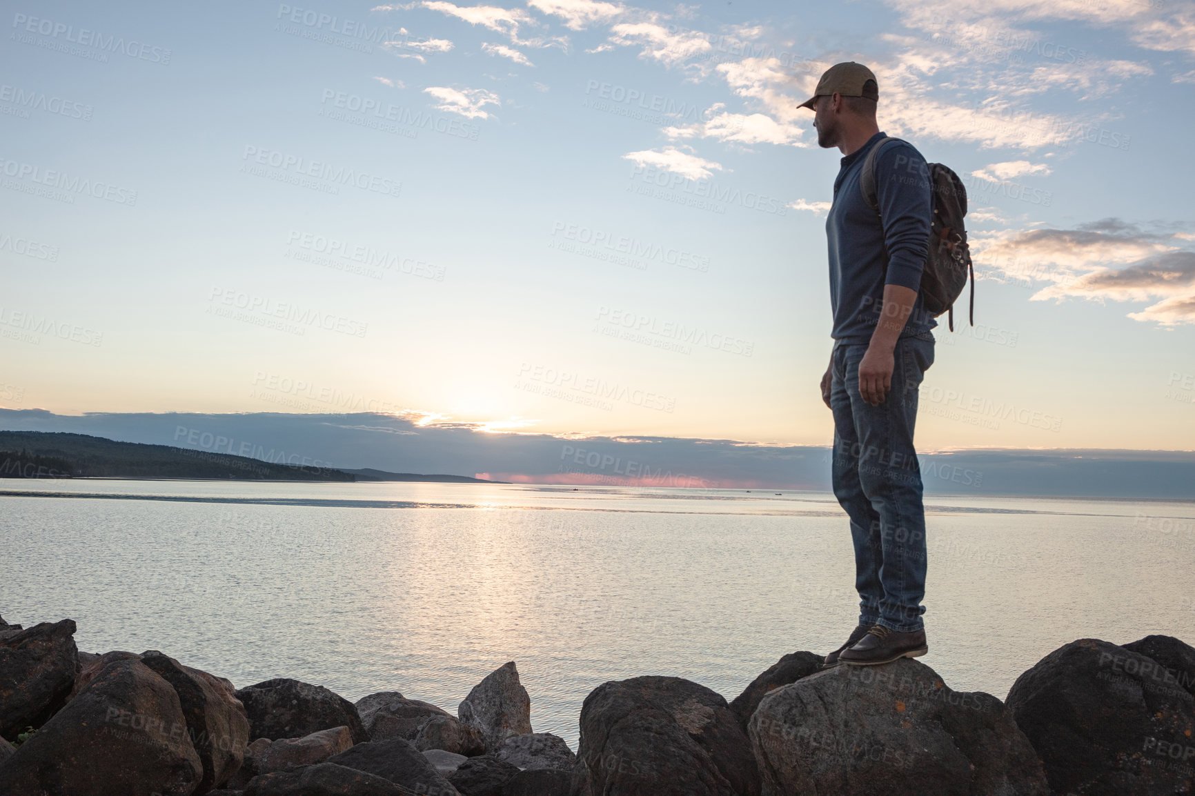 Buy stock photo Shot of a man looking at the ocean while out hiking