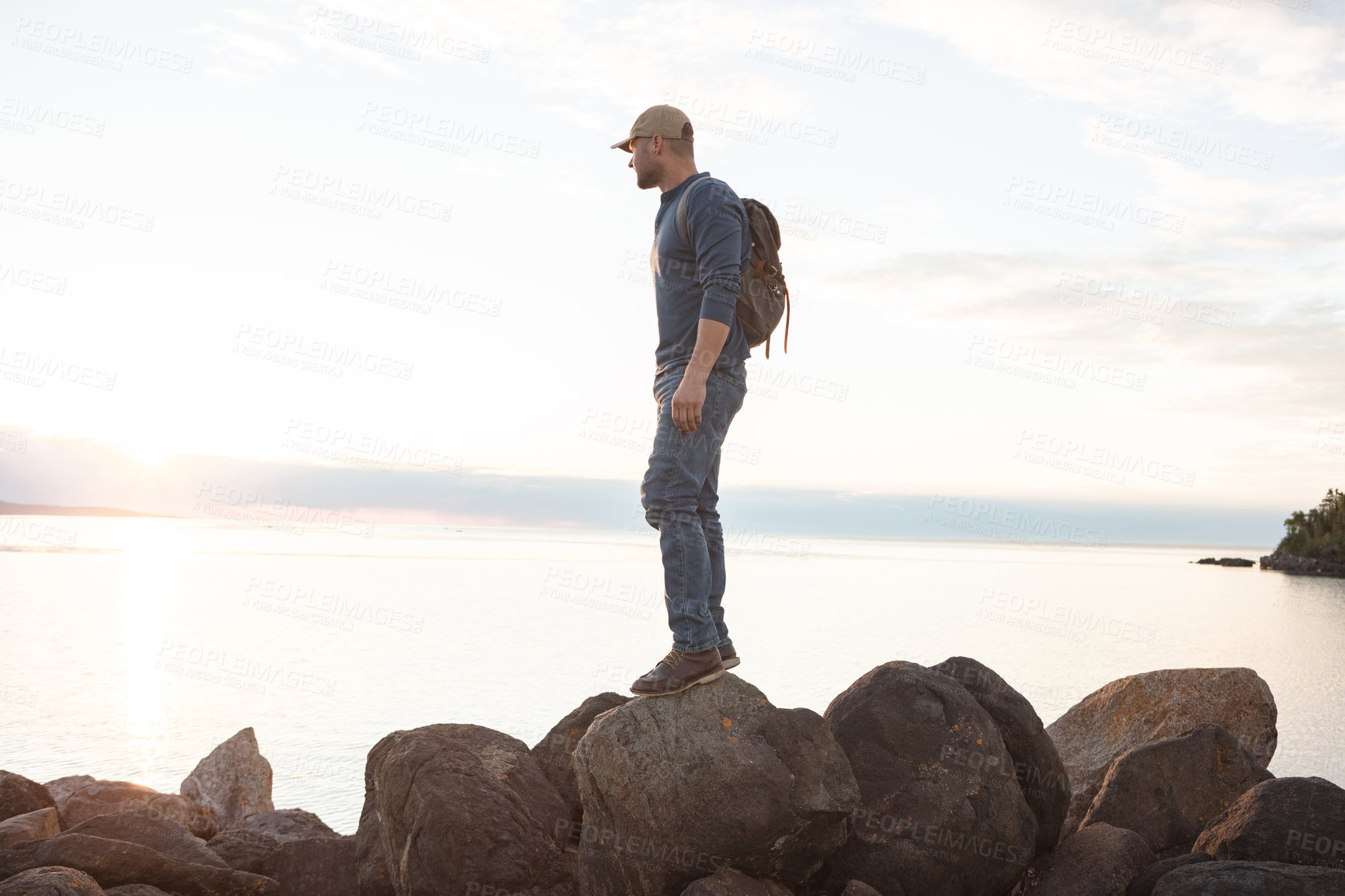 Buy stock photo Shot of a man looking at the ocean while out hiking