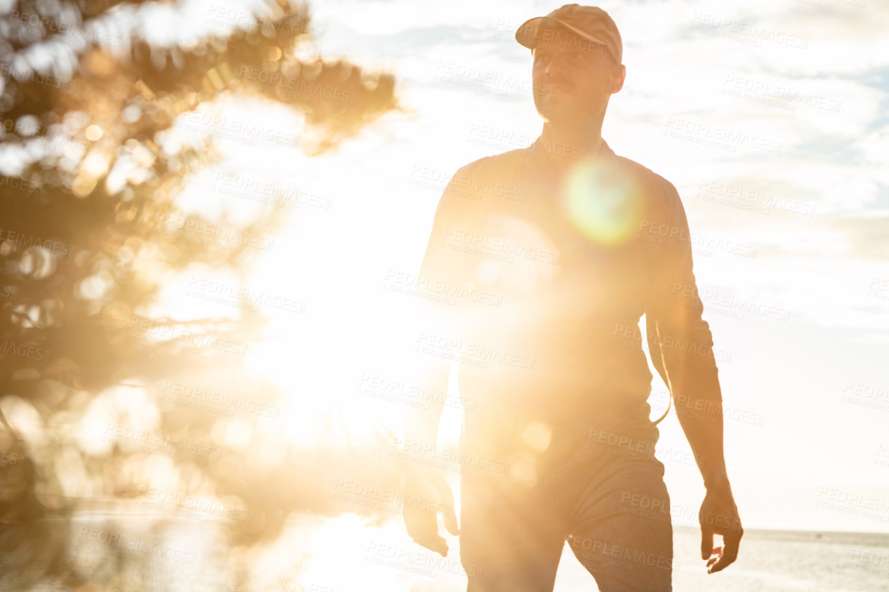 Buy stock photo Shot of a man out for a hike on a coastal trail