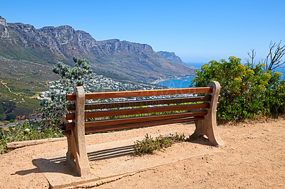 Buy stock photo Relaxing resting place along a mountain trail, with beauty in nature and peaceful harmony. Empty bench on Table Mountain, Cape Town, South Africa with a beautiful view of Lions Head and copy space. 