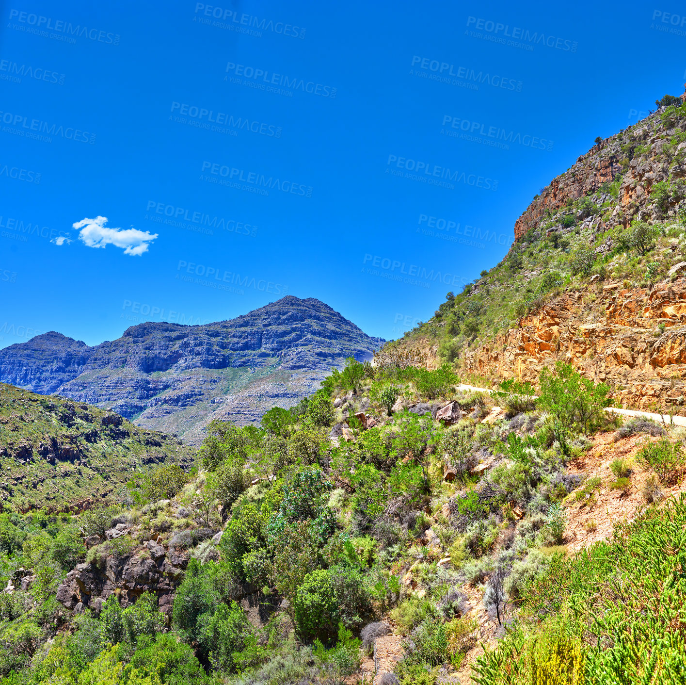 Buy stock photo Beautiful landscape of mountains covered in lush green plants with a blue sky on a summer day. Peaceful and scenic view of a peak or hills surrounded by nature outdoors on a spring afternoon