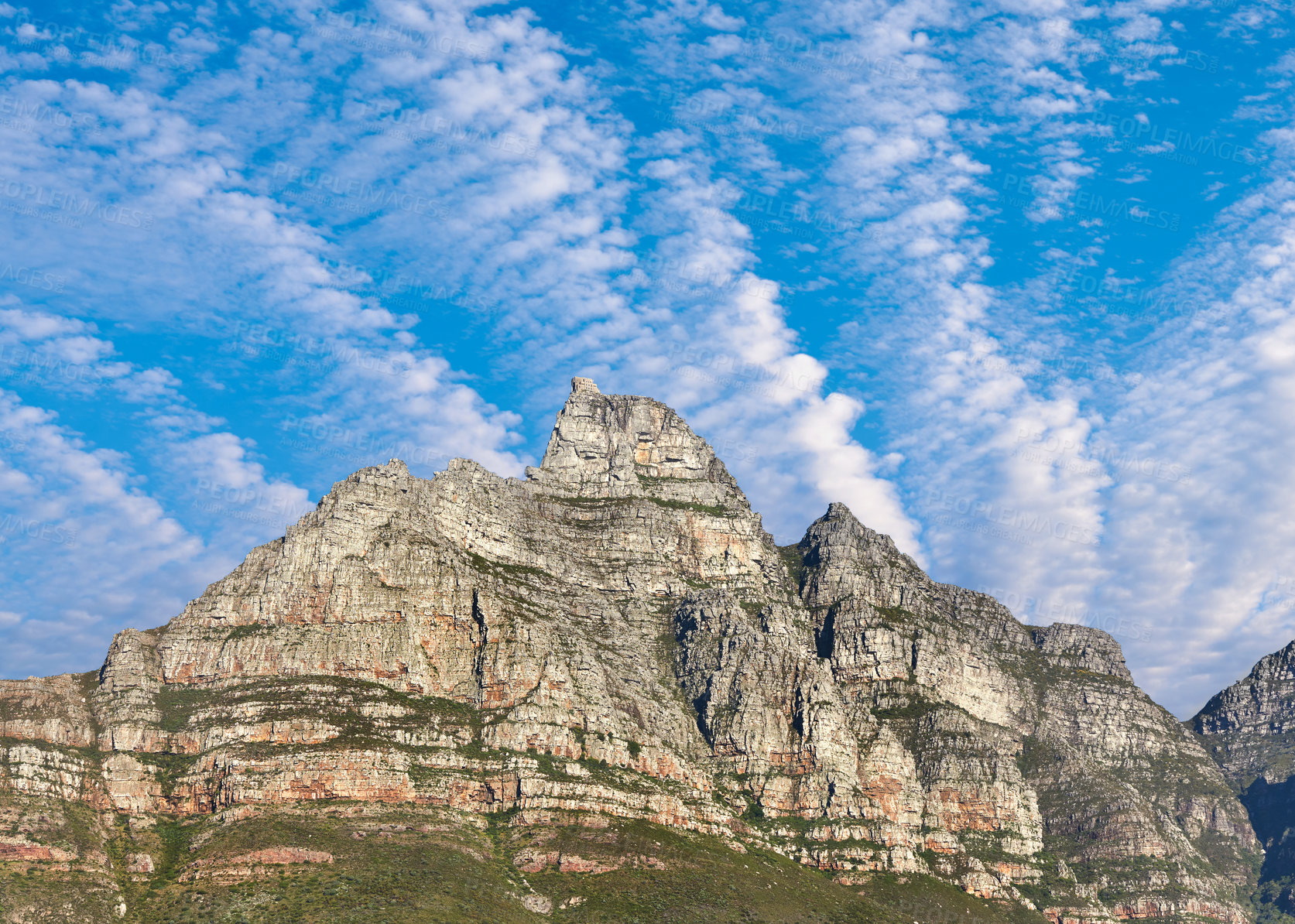 Buy stock photo Majestic Table Mountain under cloudy blue sky copy space. Beautiful below view of a rocky peak covered in lush green vegetation at a popular travel and tourism destination in Cape Town, South Africa