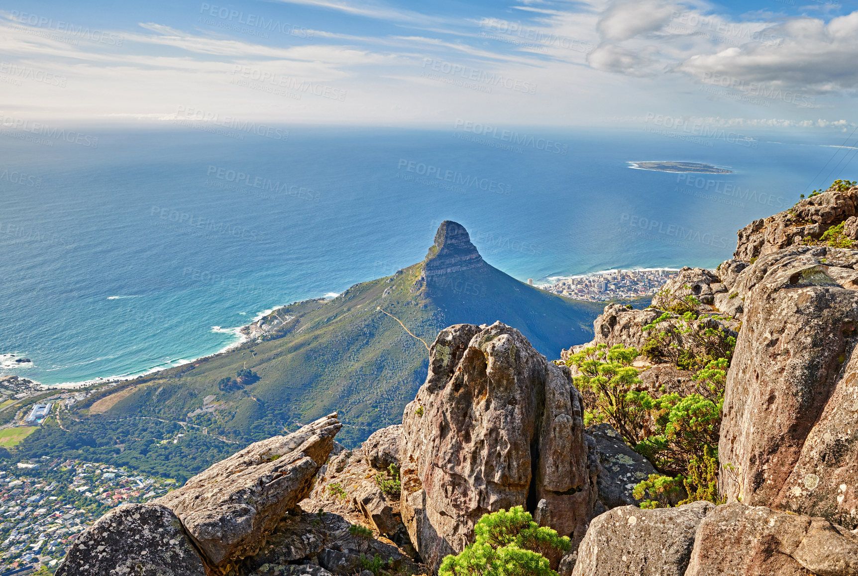 Buy stock photo Aerial view of a calm ocean and a mountain with blue cloudy sky background and copy space. Beautiful nature landscape of the sea and horizon from Table Mountain tourism attraction in Cape Town