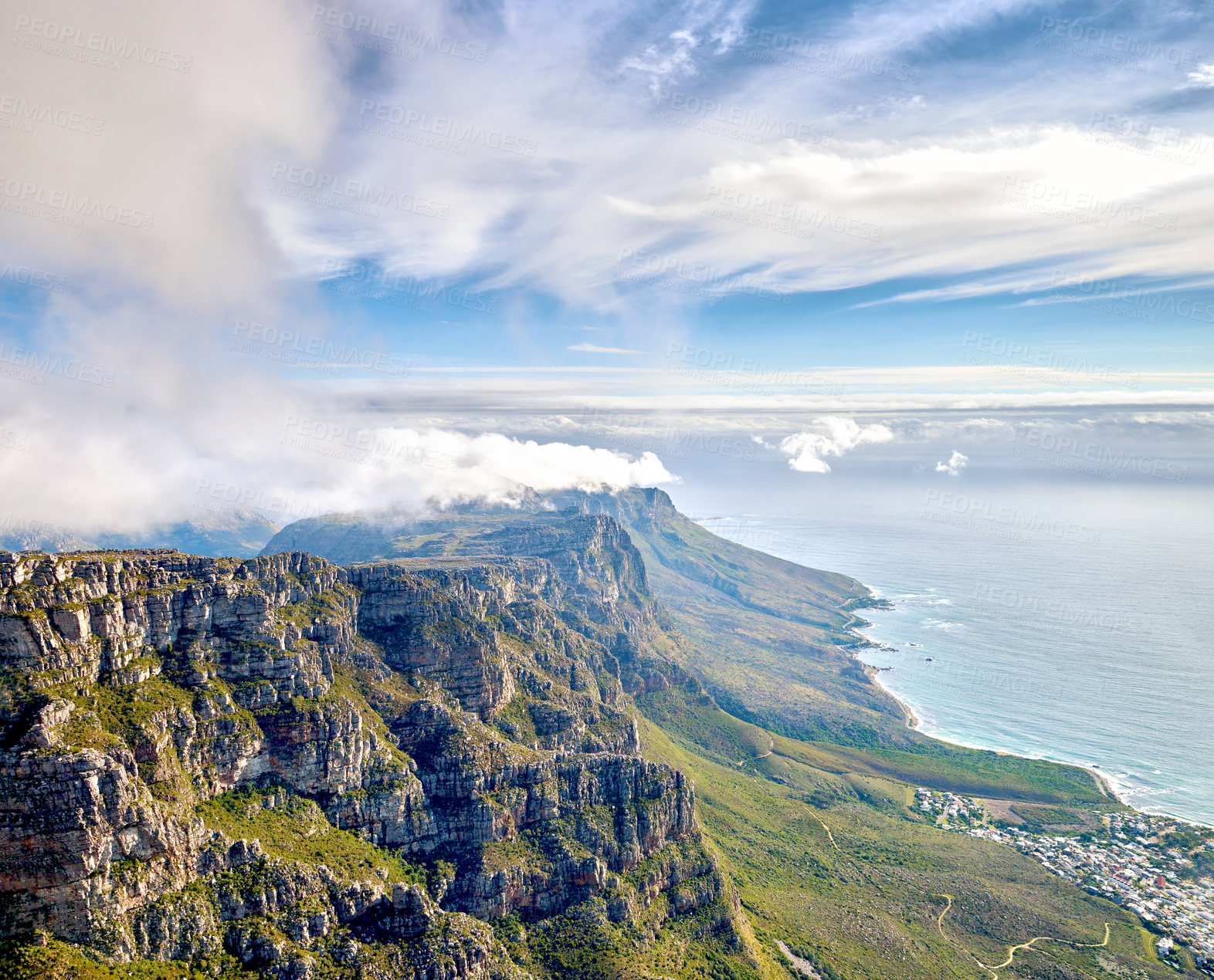 Buy stock photo Thick clouds forming on the top of Table Mountain in Cape Town with copy space. Rocky terrain with ocean views, peaceful nature in harmony with soothing view of plants, landscape and bluewater