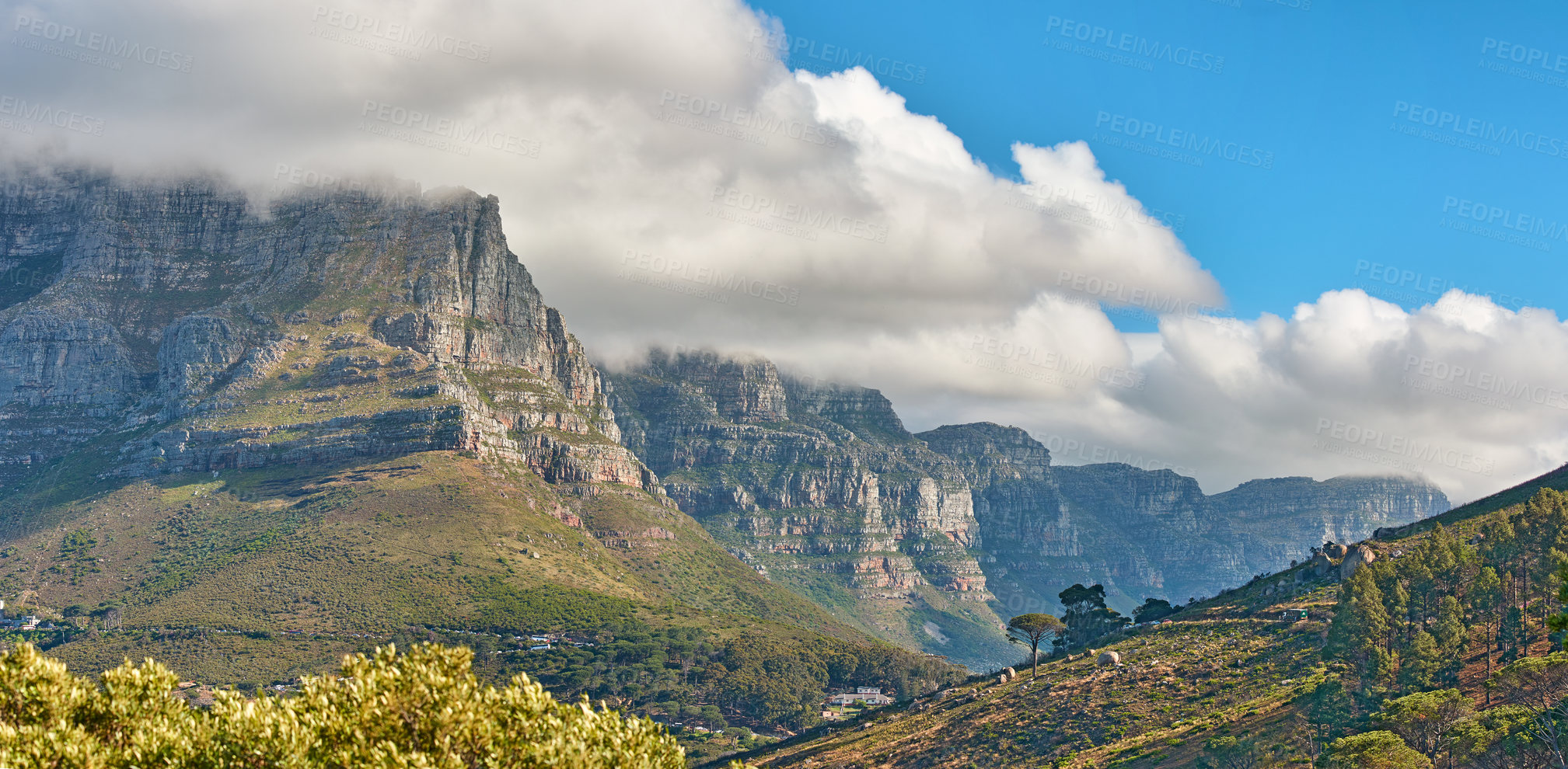 Buy stock photo Landscape banner view of a mountain with clouds rolling over in a blue sky in summer. Copyspace, scenic and panoramic view of a natural environment in the countryside. Scenery of hills and nature 