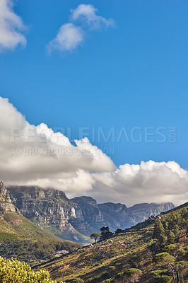 Buy stock photo Landscape of the 12 apostles mountain range in Cape Town, South Africa looking beautiful with blue sky, white and grey clouds. Stunning view of mountains and nearby trees on a hill with copy space