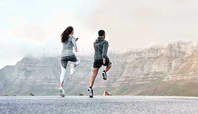 Buy stock photo Rearview shot of a sporty young man and woman exercising together outdoors