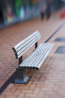 Buy stock photo Landscape of empty street bench made of wood. Isolated and weathered outdoor wooden public bench with blurred background with copy space on a sidewalk. Vintage style seating perfect for resting.