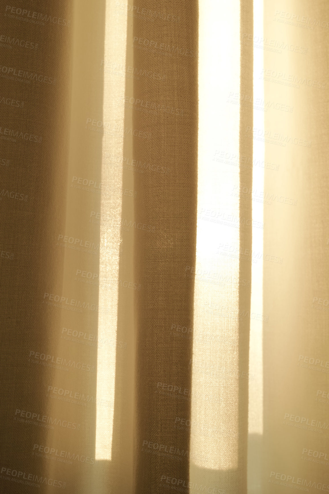 Buy stock photo Closed linen curtains hanging on window on a sunny day inside a modern home. Shadow and sunlight shining through cream cotton or beige fabric for interior decoration and copy space background